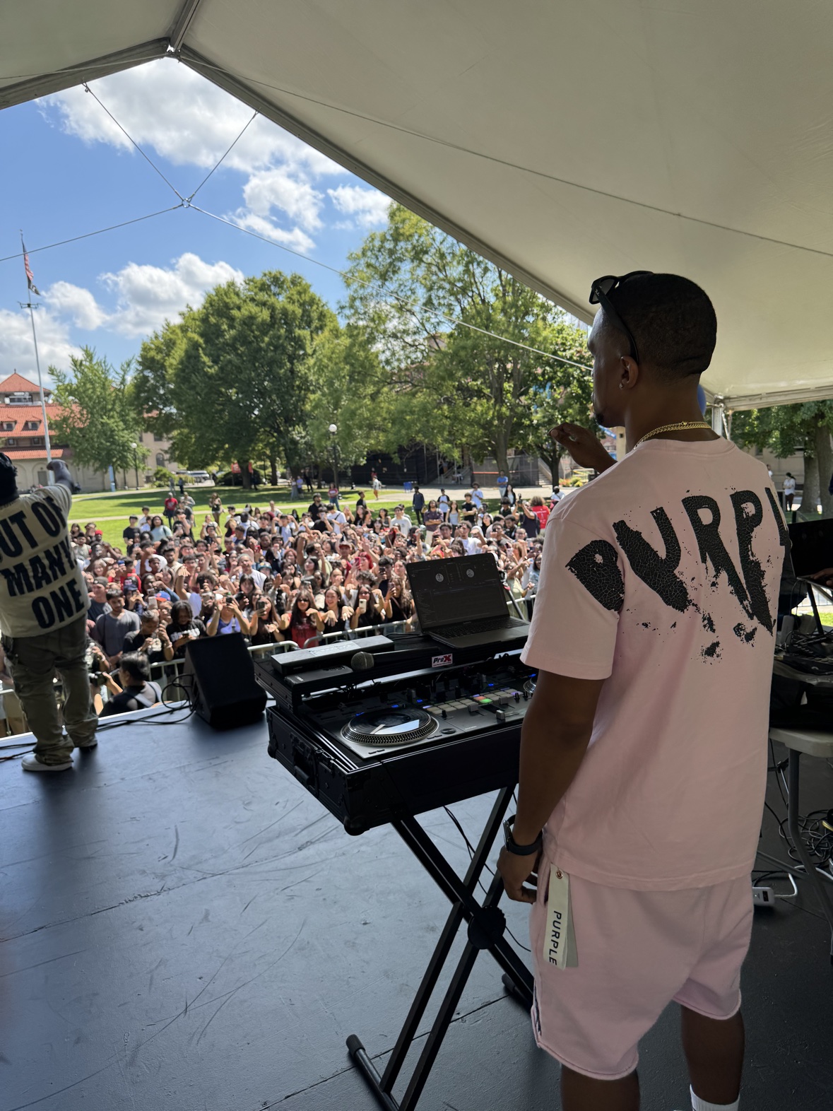 DJ Takeova at the decks facing the packed Queens College Welcome Day crowd